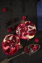 Sliced pomegranate and forest fruits with antique silver spoon. Royalty Free Stock Photo