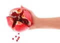Sliced pomegranate in hand and seeds