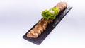 Sliced pork rolls with herbs on black rock plate Royalty Free Stock Photo