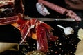 Sliced prosciutto crudo on cutting board.