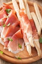 Sliced prosciutto ham and grissini bread sticks Royalty Free Stock Photo