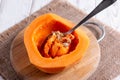 Sliced pumpkin on a cutting board. Remove seeds with a spoon Royalty Free Stock Photo