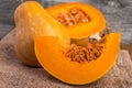 sliced pumpkin on rustic table and burlap