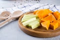 Sliced pumpkin on a wooden board. Home cooking food with pumpkin. Royalty Free Stock Photo