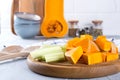 Sliced pumpkin on a wooden board. Home cooking food with pumpkin. Royalty Free Stock Photo