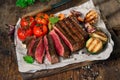 Sliced rare grilled steak with grilled vegetables close up Royalty Free Stock Photo