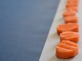 Sliced raw carrots on a white background and a blue copy space Royalty Free Stock Photo