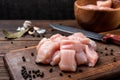 Sliced raw chicken breast or fillets on dark wooden. Royalty Free Stock Photo