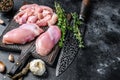 Sliced Raw Chicken thigh fillet on a wooden cutting board. Black background. Top view. Copy space Royalty Free Stock Photo