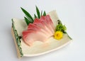 Sliced raw Hamachi sashimi on plate