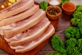 Sliced raw pork shoulder with spices and herbs on wooden board Royalty Free Stock Photo