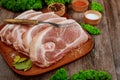 Sliced raw pork shoulder with spices on wooden board Royalty Free Stock Photo