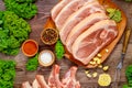 Sliced raw pork shoulder with spices on wooden board Royalty Free Stock Photo