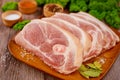 Sliced raw pork shoulder with spices on wooden board Royalty Free Stock Photo