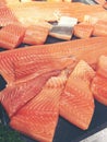 Sliced raw salmon or fresh salmon. Salmon fillets for sale at market displayed with a patchwork effect. Many fresh salmon fish