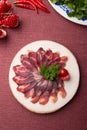 Sliced raw smoked meat served on wooden board Royalty Free Stock Photo