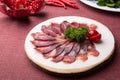 Sliced raw smoked meat served on wooden board Royalty Free Stock Photo