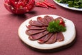 Sliced raw smoked meat served on wooden board Royalty Free Stock Photo