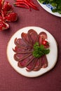 Sliced raw smoked meat served on wooden board Royalty Free Stock Photo
