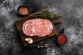 Sliced raw smoked sausage, on black dark stone table background, top view flat lay, with copy space for text Royalty Free Stock Photo