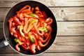 Sliced raw sweet pepper in a frying pan