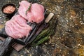 Sliced Raw turkey breast fillet meat on a cutting board with butcher knife. Brown background. Top View. Copy space Royalty Free Stock Photo