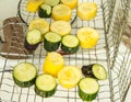 Sliced raw yellow and green zucchini slices on a grill for frying, vegetarian concepts, summer day outdoors Royalty Free Stock Photo