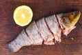 Sliced ready-to-cook tench fish and lemon Royalty Free Stock Photo