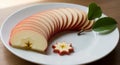 Beautifully Sliced Red Apple Presented Artistically on a White Plate with Greens Royalty Free Stock Photo