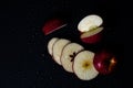 Sliced red apple isolated on black background. Royalty Free Stock Photo