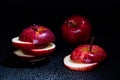 Sliced red apple isolated on black background. Royalty Free Stock Photo