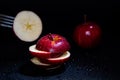 Sliced red apple isolated on black background. Royalty Free Stock Photo