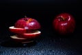 Sliced red apple isolated on black background. Royalty Free Stock Photo