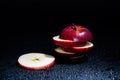 Sliced red apple isolated on black background. Royalty Free Stock Photo