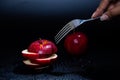 Sliced red apple isolated on black background. Royalty Free Stock Photo