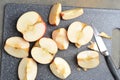 Sliced red apples on a Board with a knife