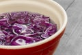 Sliced red cabbage soaking in water in a ceramic bowl. Royalty Free Stock Photo