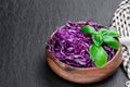 Sliced red cabbage in wooden bowl on black stone background Royalty Free Stock Photo