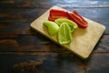 Sliced red and green bell peppers on a cutting board. Organic food and coocking. Royalty Free Stock Photo