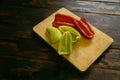 Sliced red and green bell peppers on a cutting board. Organic food and coocking. Royalty Free Stock Photo