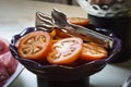Sliced red large tomatoes on a purple bowl on a table Royalty Free Stock Photo