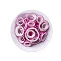 Sliced red onion in a ceramic bowl isolated on white background, top view Royalty Free Stock Photo