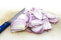 Sliced Red Onion with Knife and Chopping Block.