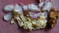 Sliced red onion, white onion, galangal on red kitchen board Royalty Free Stock Photo