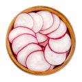 Sliced red radishes in a wooden bowl