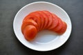 Sliced red ripe tomatoes on a white plate Royalty Free Stock Photo