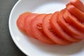 Sliced red ripe tomatoes on a white plate Royalty Free Stock Photo
