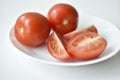 Sliced red tomatoes close-up on a plate Royalty Free Stock Photo