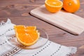 Sliced ripe appetizing delicious orange on cutting board brown t Royalty Free Stock Photo