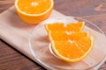 Sliced ripe appetizing delicious orange on cutting board brown t Royalty Free Stock Photo